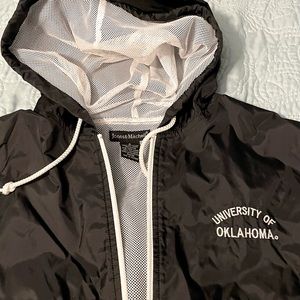 OU Sooners Hooded Black Rain windbreaker jacket.
